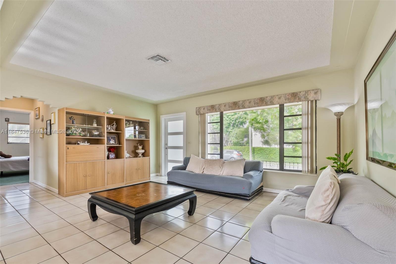 1621 Southwest 23rd Avenue Miami, FL 33145 - Photo 1 of 25 a living room with furniture and a large window