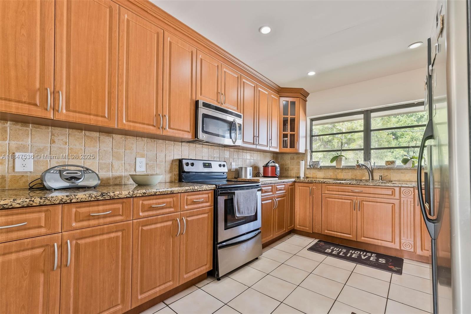1621 Southwest 23rd Avenue Miami, FL 33145 - Photo 11 of 25 a kitchen with stainless steel appliances granite countertop a stove sink and cabinets