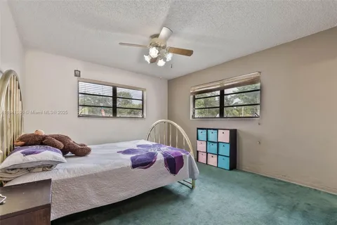 a bedroom with a bed furniture a window and closet