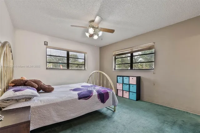 a bedroom with a bed furniture a window and closet