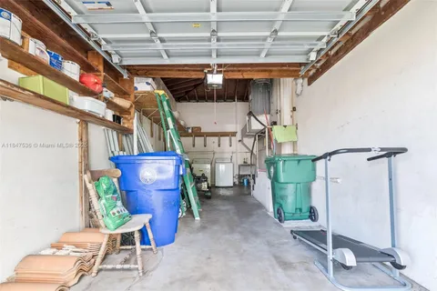 a view of a garage with wooden chairs