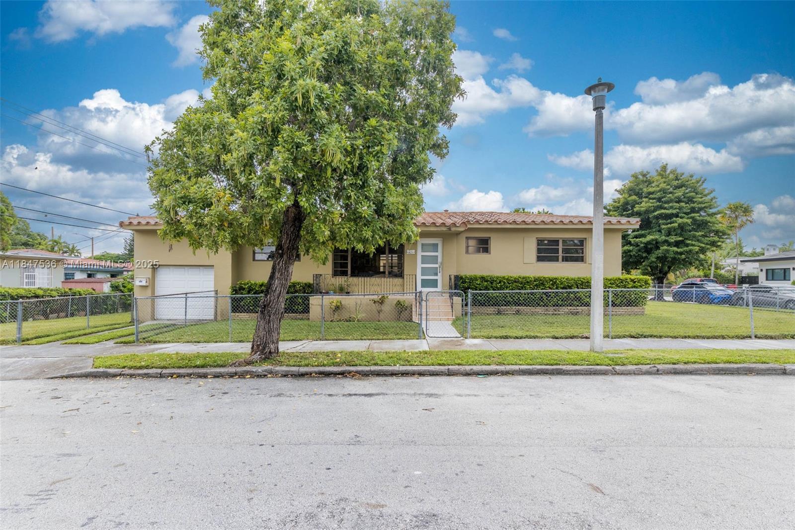 1621 Southwest 23rd Avenue Miami, FL 33145 - Photo 2 of 25 a view of street with houses in back yard