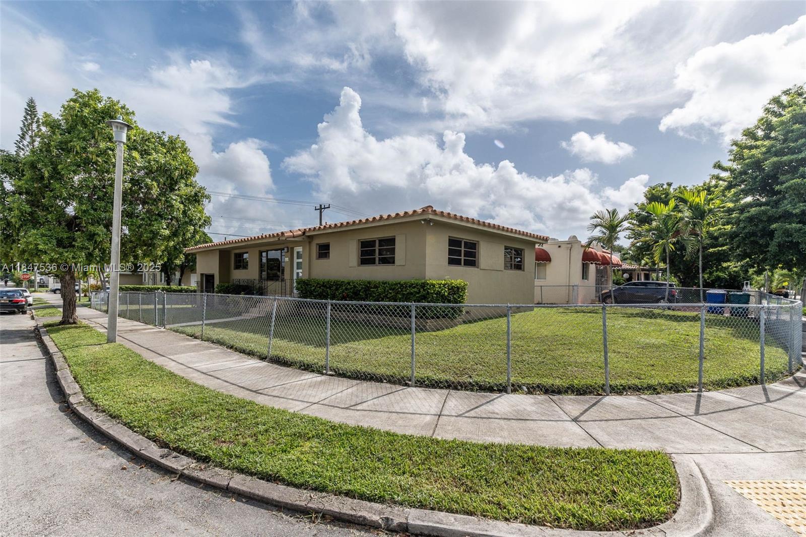 1621 Southwest 23rd Avenue Miami, FL 33145 - Photo 22 of 25 a view of a house with a big yard and potted plants
