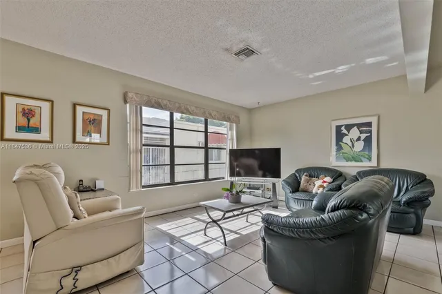 a living room with furniture a couch and a flat screen tv