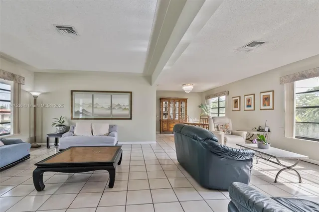 a living room with furniture rug and window