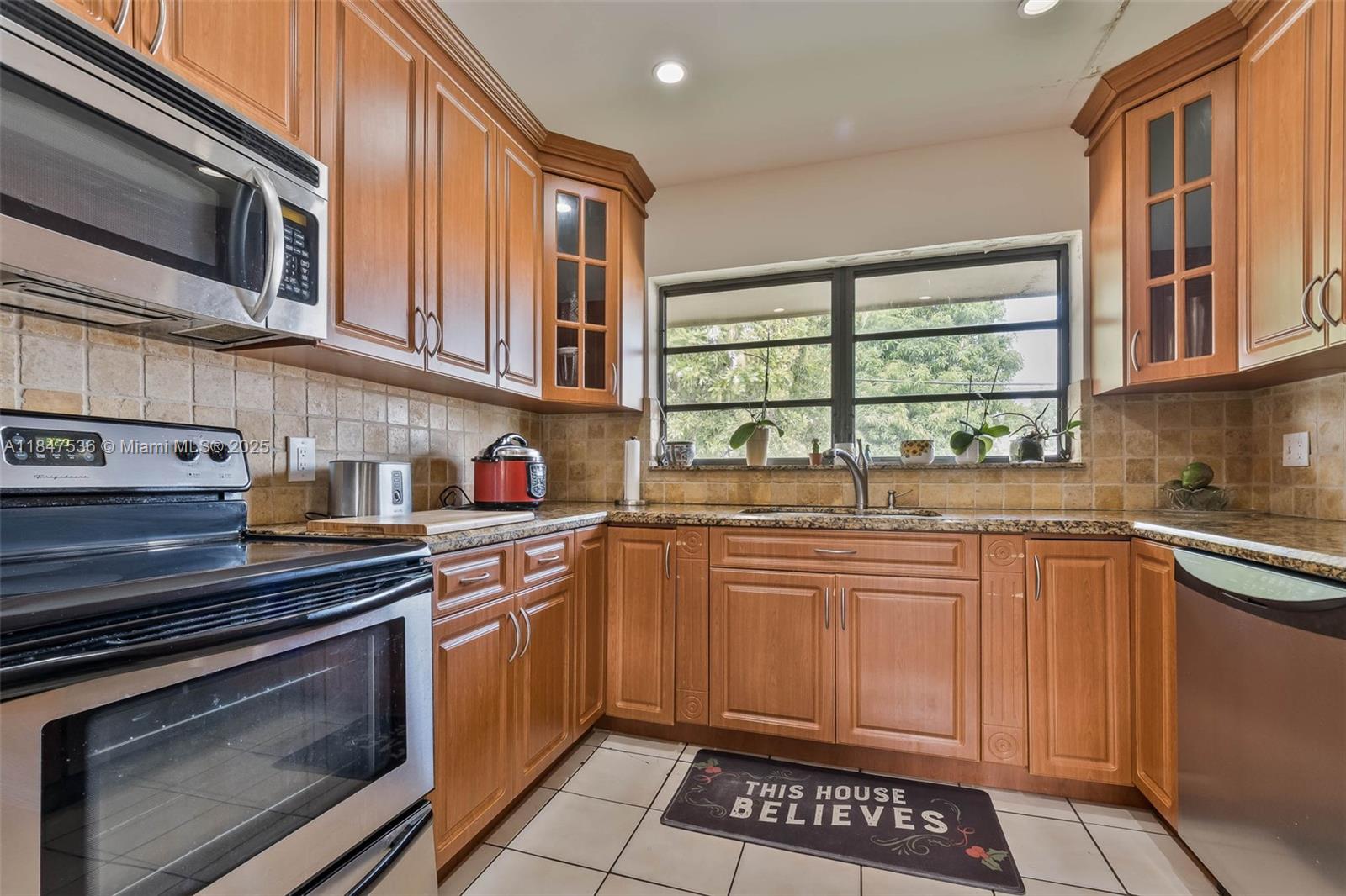 1621 Southwest 23rd Avenue Miami, FL 33145 - Photo 10 of 25 a kitchen with stainless steel appliances granite countertop a stove and a microwave