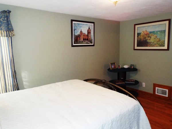 219 Prospect Street Ashland, MA 01721 - Photo 14 of 21 a bedroom with a bed and a painting on the wall