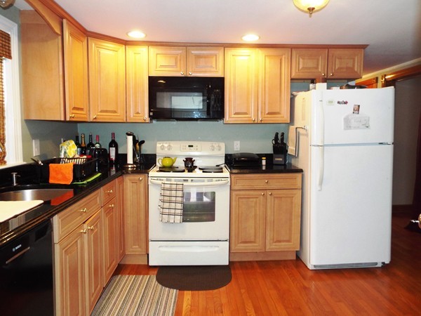 219 Prospect Street Ashland, MA 01721 - Photo 4 of 21 a kitchen with a refrigerator a stove a microwave and cabinets
