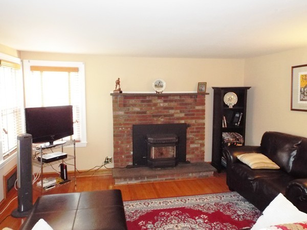 219 Prospect Street Ashland, MA 01721 - Photo 7 of 21 a living room with furniture a fireplace and a flat screen tv