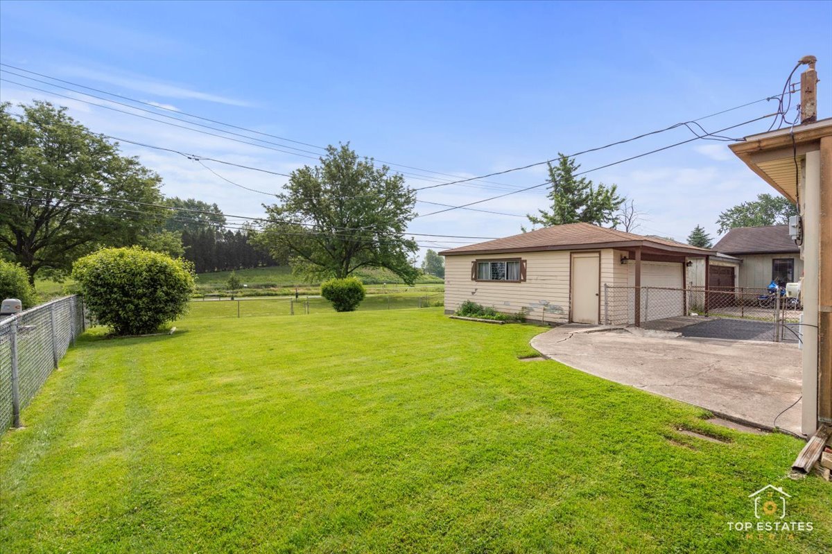 3604 Owl Drive Rolling Meadows, IL 60008 - Photo 27 of 43 a front view of a house with a yard and garage