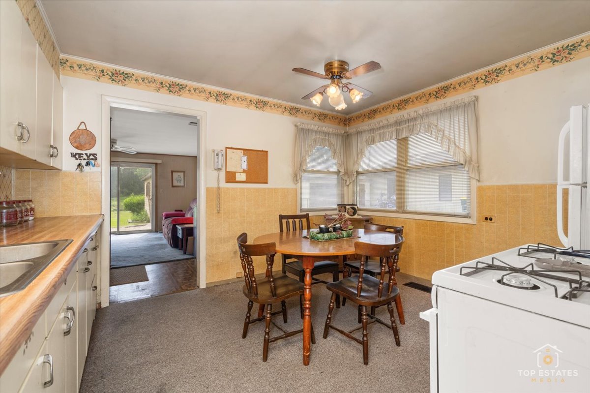 3604 Owl Drive Rolling Meadows, IL 60008 - Photo 8 of 43 a view of a dining room with furniture and a chandelier