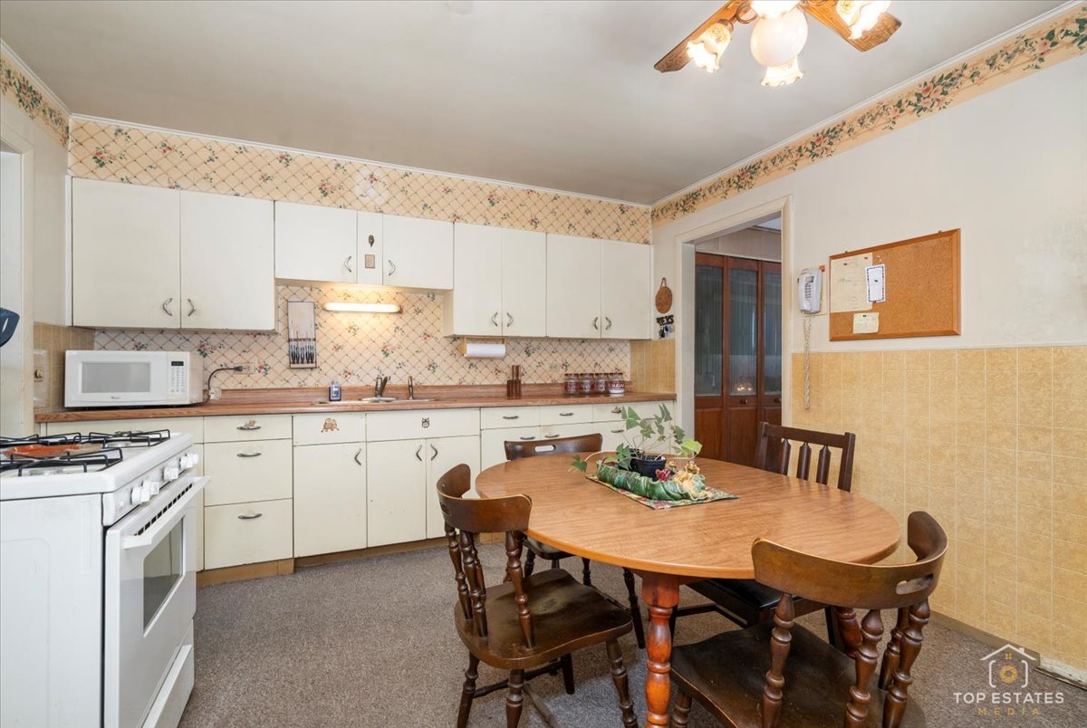 3604 Owl Drive Rolling Meadows, IL 60008 - Photo 10 of 43 a kitchen with a dining table chairs and white cabinets