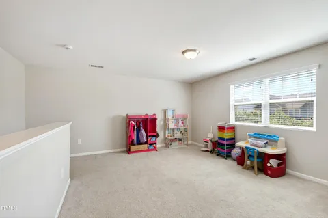 a view of play room with windows and toys