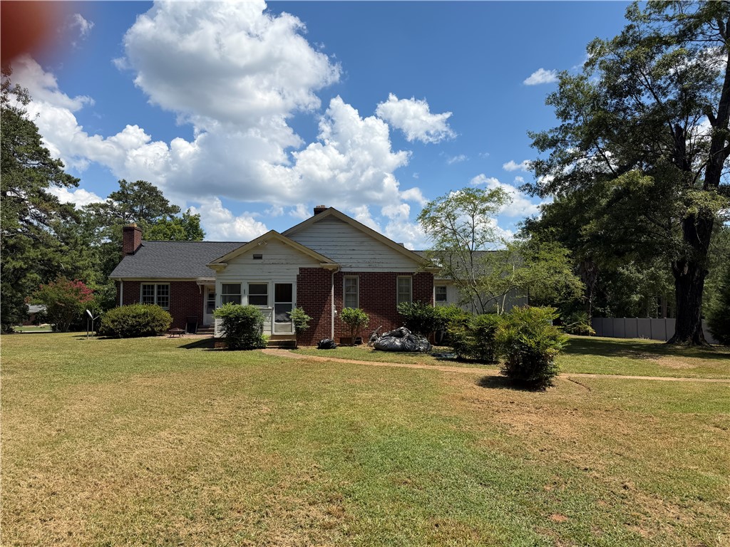 715 Concord Road Anderson, SC 29621 - Photo 5 of 24 A charming brick home, nestled amidst mature trees, features a welcoming front porch and established landscaping.