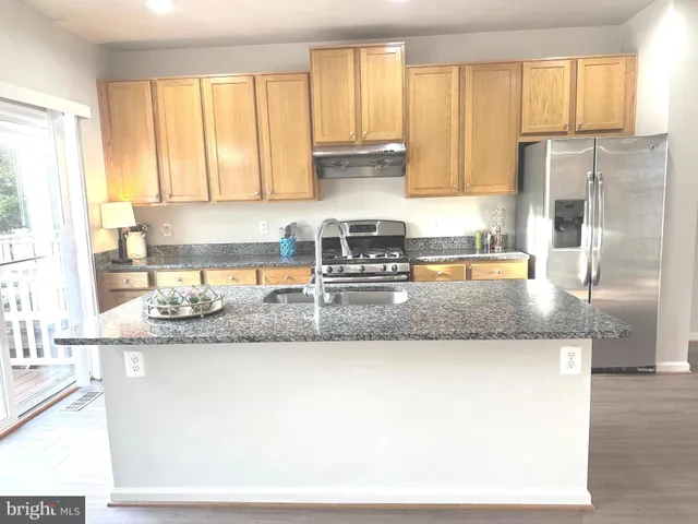 a kitchen with a window a sink and a counter