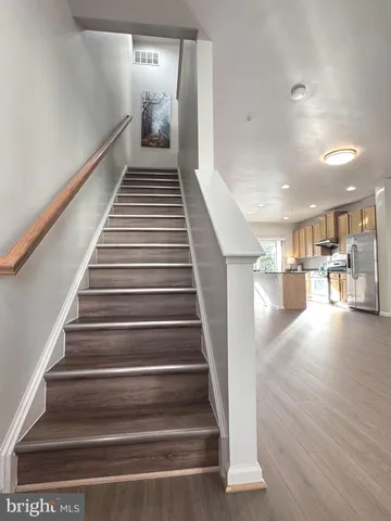 a view of entryway and hall with wooden floor