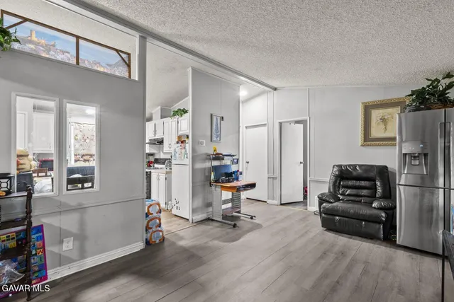 a view of a livingroom with workspace and a window