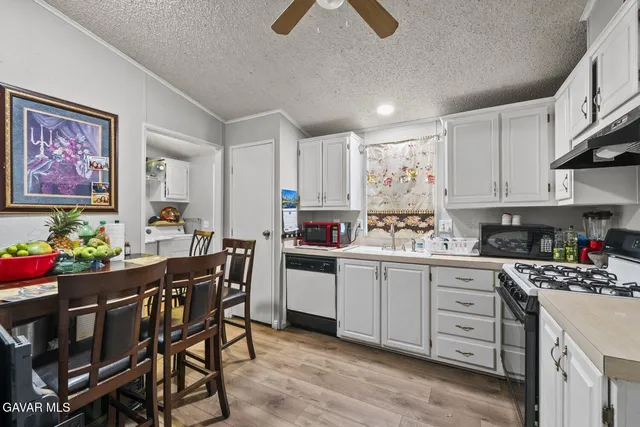 a kitchen with stainless steel appliances a stove a refrigerator and a sink