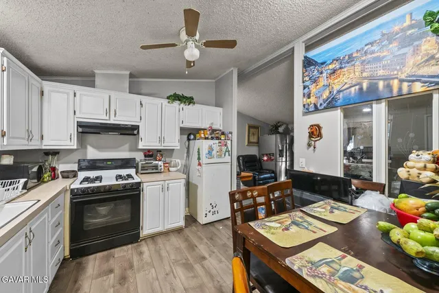 a kitchen with stainless steel appliances a stove a sink and a refrigerator