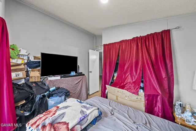 a bed room with bed and a flat screen tv