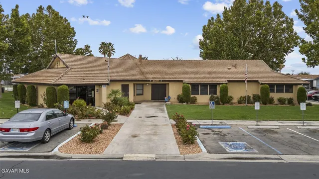 a swimming pool with outdoor seating and yard in the back