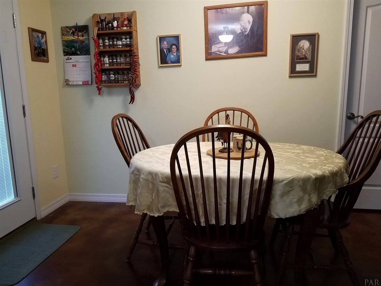 4708 Old Guernsey Road Pace, FL 32571 - Photo 16 of 46 a view of a dining room with furniture