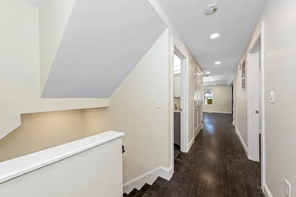 a view of hallway with wooden floor