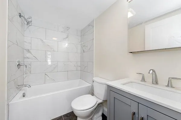 a bathroom with a sink a toilet and bathtub