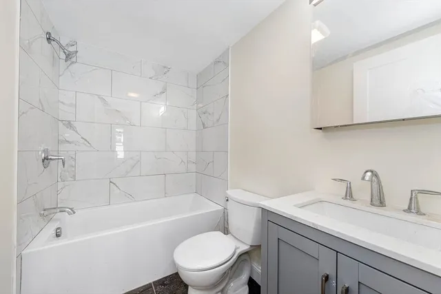 a bathroom with a sink a toilet and bathtub