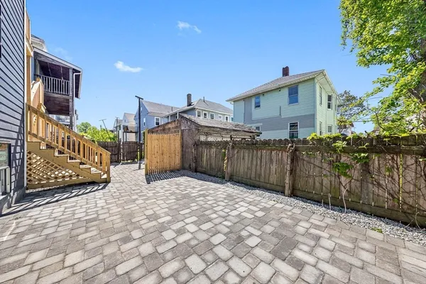 a view of a house with a wooden fence