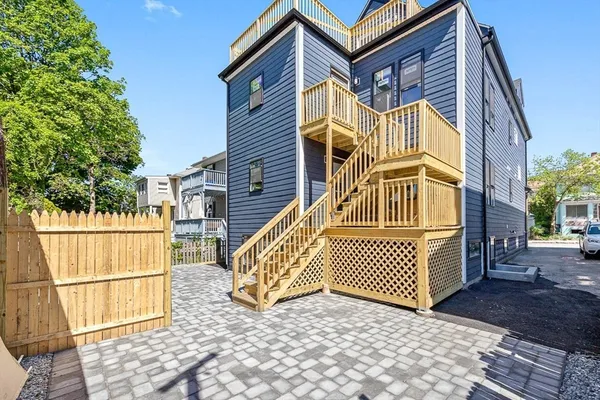 a view of a house with a wooden deck