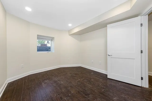 an empty room with wooden floor and closet