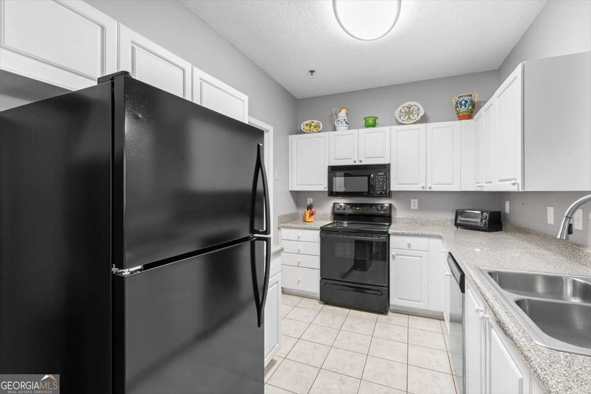803 Spring Heights Lane, Unit 8 Smyrna, GA 30080 - Photo 11 of 46 a kitchen with a refrigerator and a stove top oven