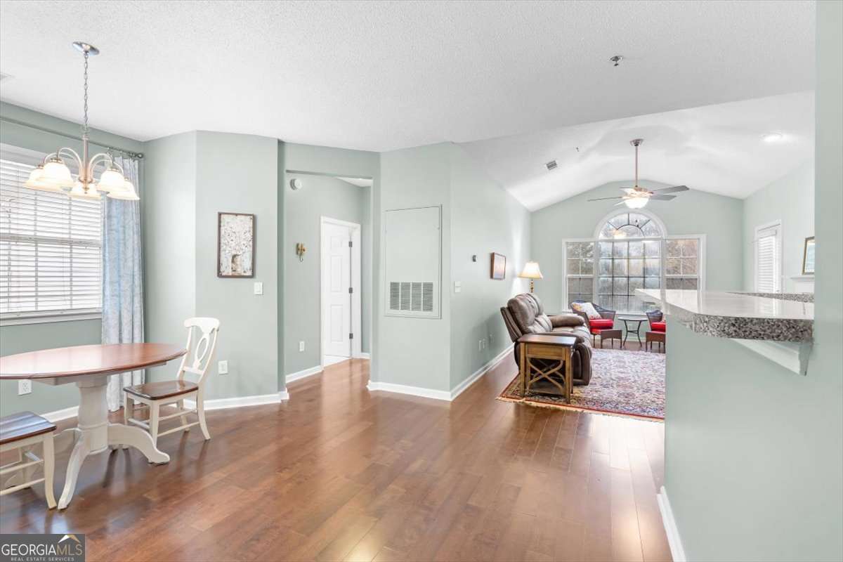 803 Spring Heights Lane, Unit 8 Smyrna, GA 30080 - Photo 17 of 46 a living room with furniture and a chandelier