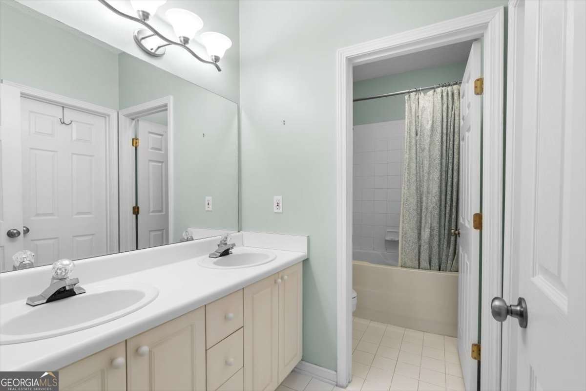 803 Spring Heights Lane, Unit 8 Smyrna, GA 30080 - Photo 22 of 46 a bathroom with a sink a mirror and a bathtub