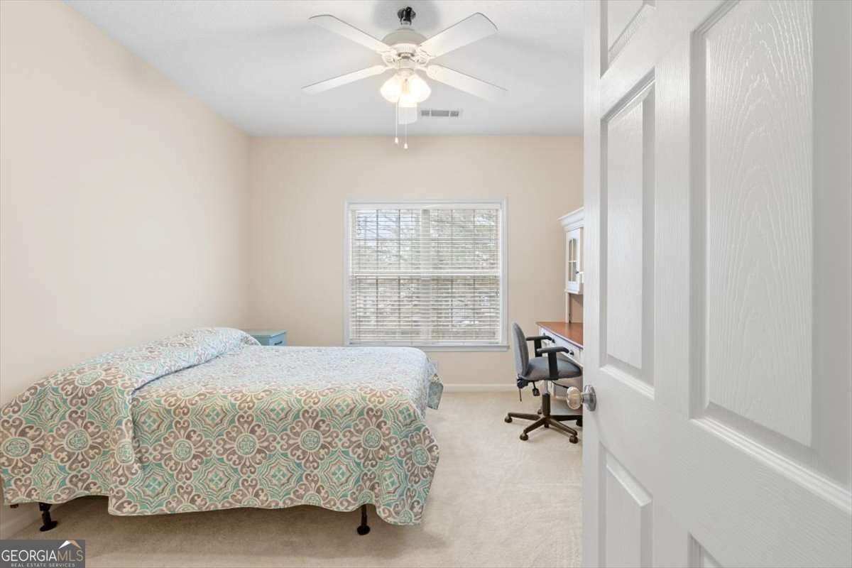 803 Spring Heights Lane, Unit 8 Smyrna, GA 30080 - Photo 24 of 46 a bedroom with a bed and a chandelier