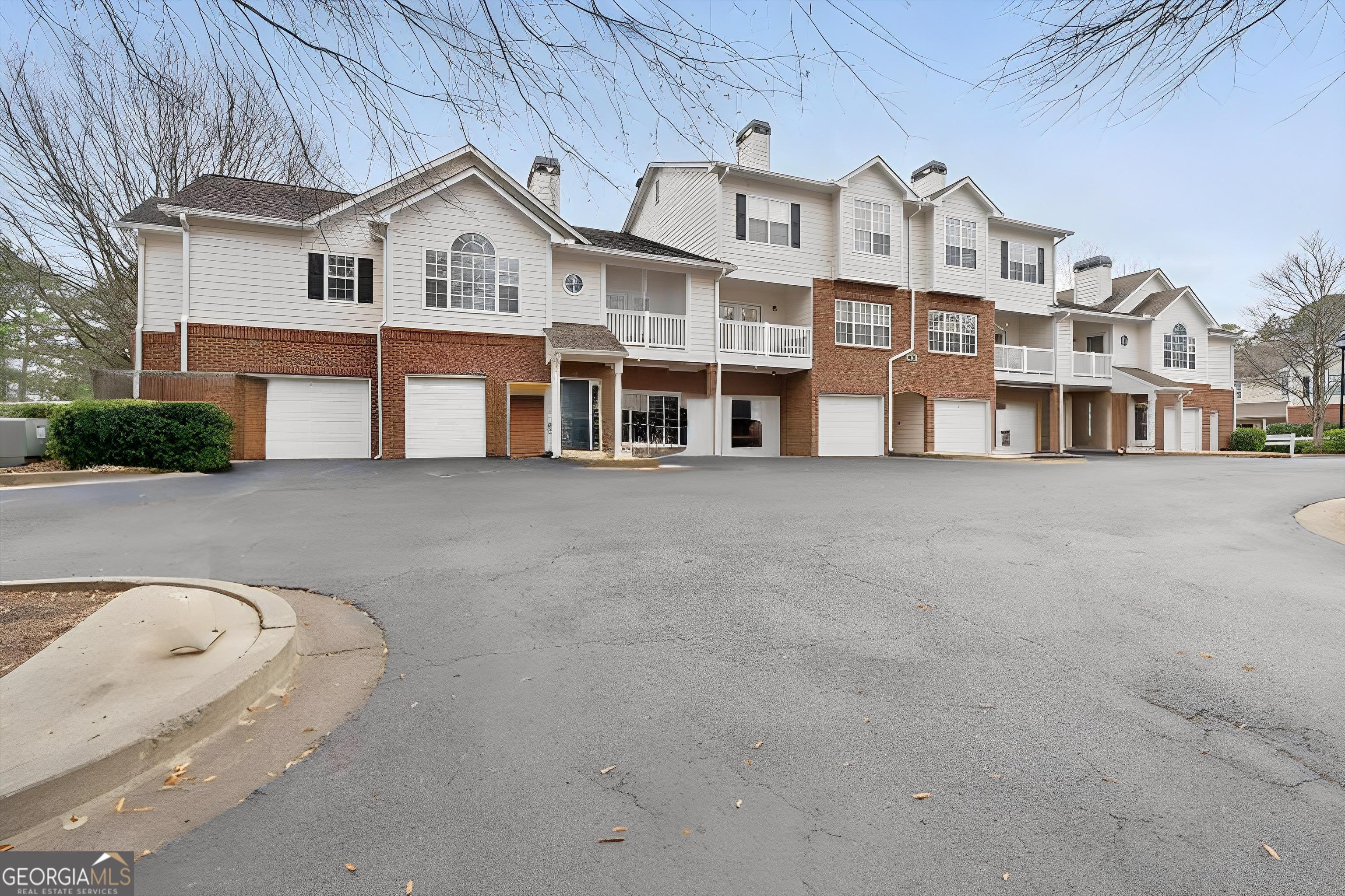 803 Spring Heights Lane, Unit 8 Smyrna, GA 30080 - Photo 32 of 46 a view of a white building among the street with tall buildings