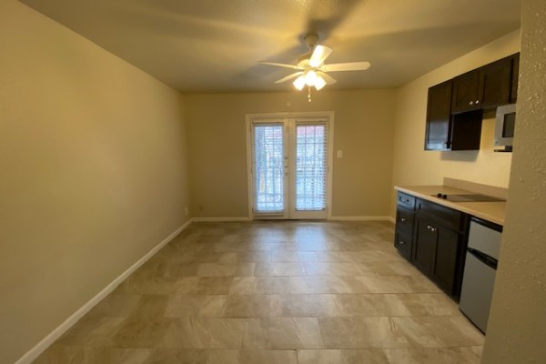 2402 Rio Grande Street, Unit 6 Austin, TX 78705 - Photo 2 of 3 Bright and open, this space features convenient French doors and a compact kitchen.