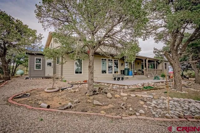 a front view of a house with a trees