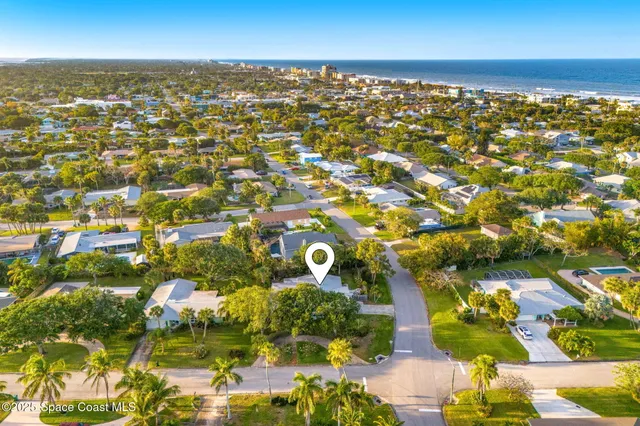 an aerial view of residential houses with outdoor space
