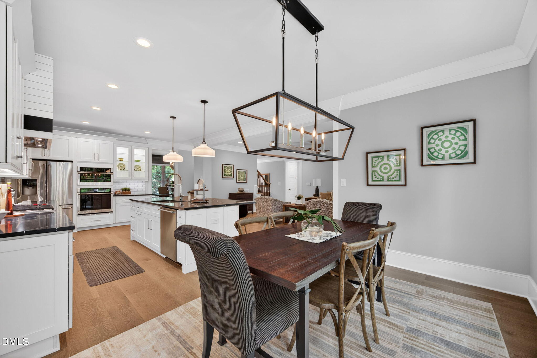 3417 Edgemont Drive Raleigh, NC 27612 - Photo 22 of 83 a view of a dining room and livingroom with furniture wooden floor a chandelier