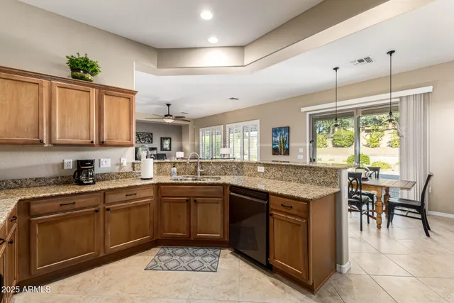 a kitchen with stainless steel appliances kitchen island granite countertop a sink and cabinets