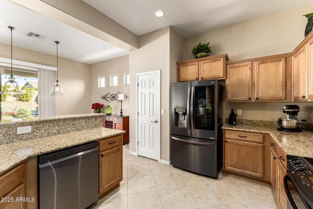 a kitchen with stainless steel appliances a stove a sink and a microwave