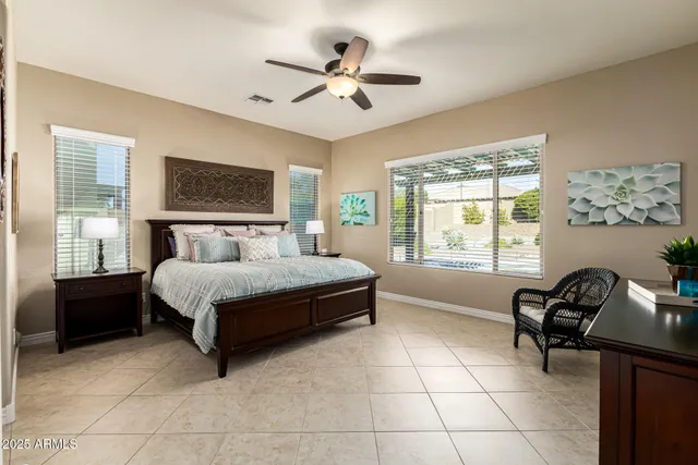 a bedroom with a bed a window and a television