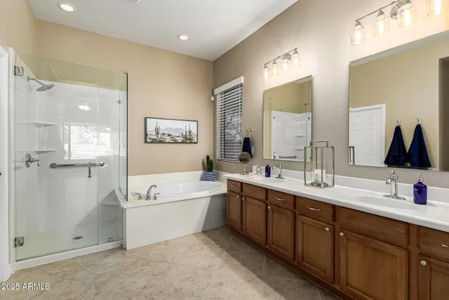 a spacious bathroom with a double vanity sink a mirror a vanity and next to a window