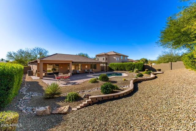 a view of a porch with furniture and a yard