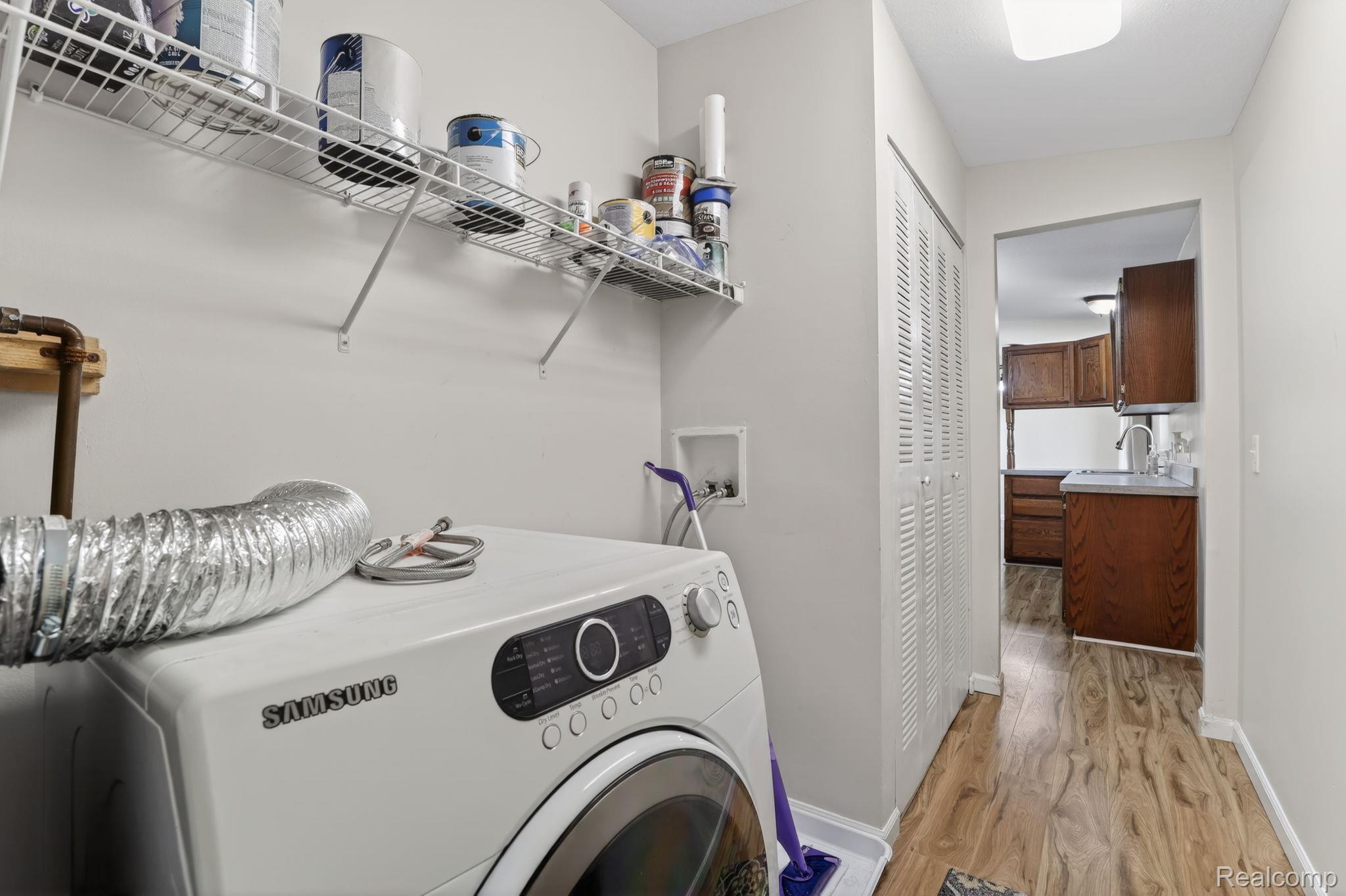 4050 West Thompson Road Linden, MI 48451 - Photo 28 of 36 Laundry area featuring washer / clothes dryer and light wood finished floors