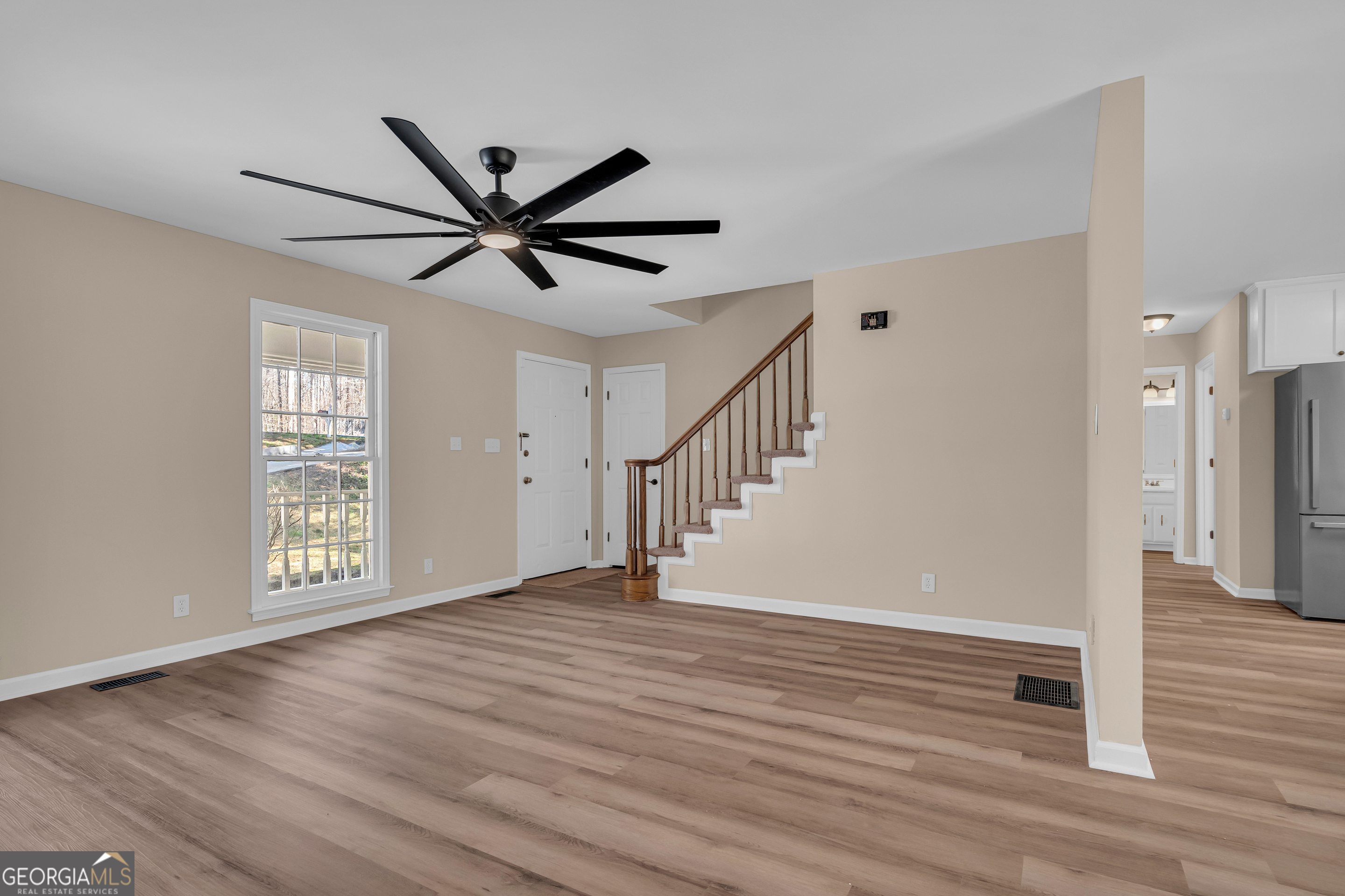 694 Lovers Lane Toccoa, GA 30577 - Photo 22 of 50 a view of an empty room with window and wooden floor