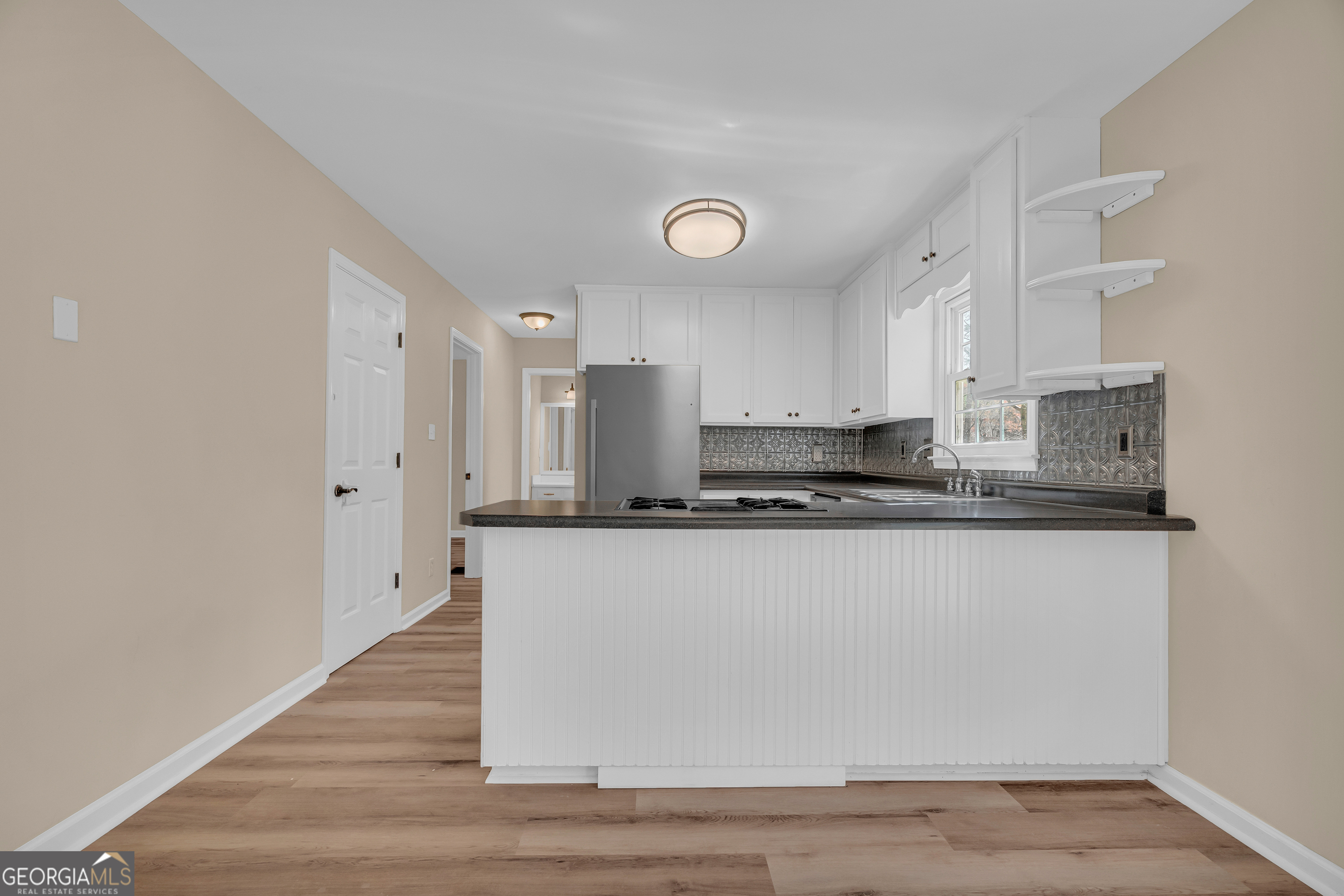 694 Lovers Lane Toccoa, GA 30577 - Photo 25 of 50 a large white kitchen with wooden floor