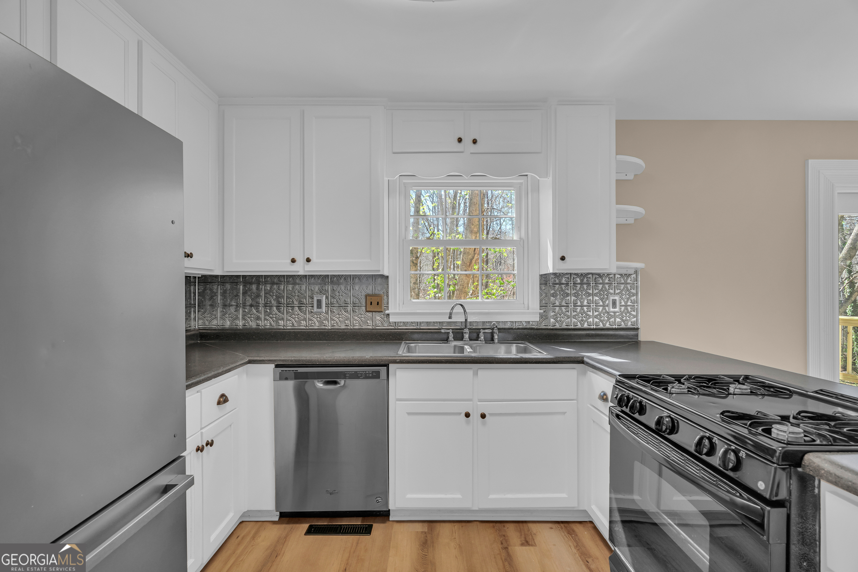 694 Lovers Lane Toccoa, GA 30577 - Photo 26 of 50 a kitchen with stainless steel appliances granite countertop a stove and a sink